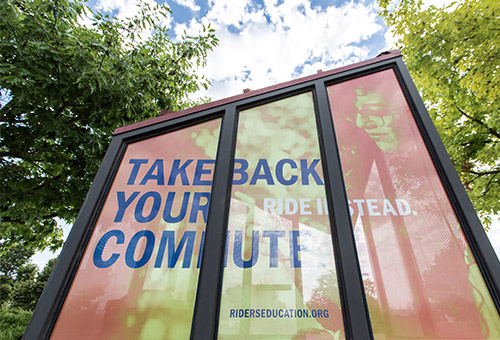 Bus stop signage saying "Take back your commute"